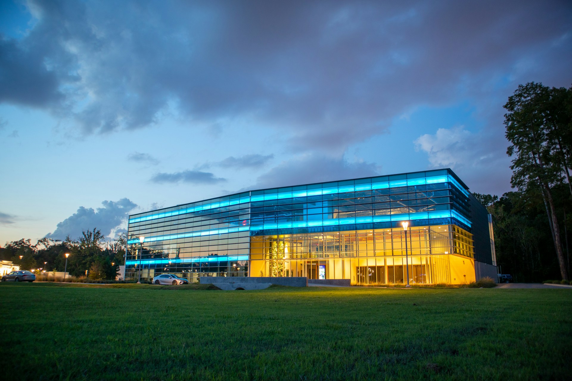 Low-rise commercial property with glass frontage and maintained grounds at dusk
