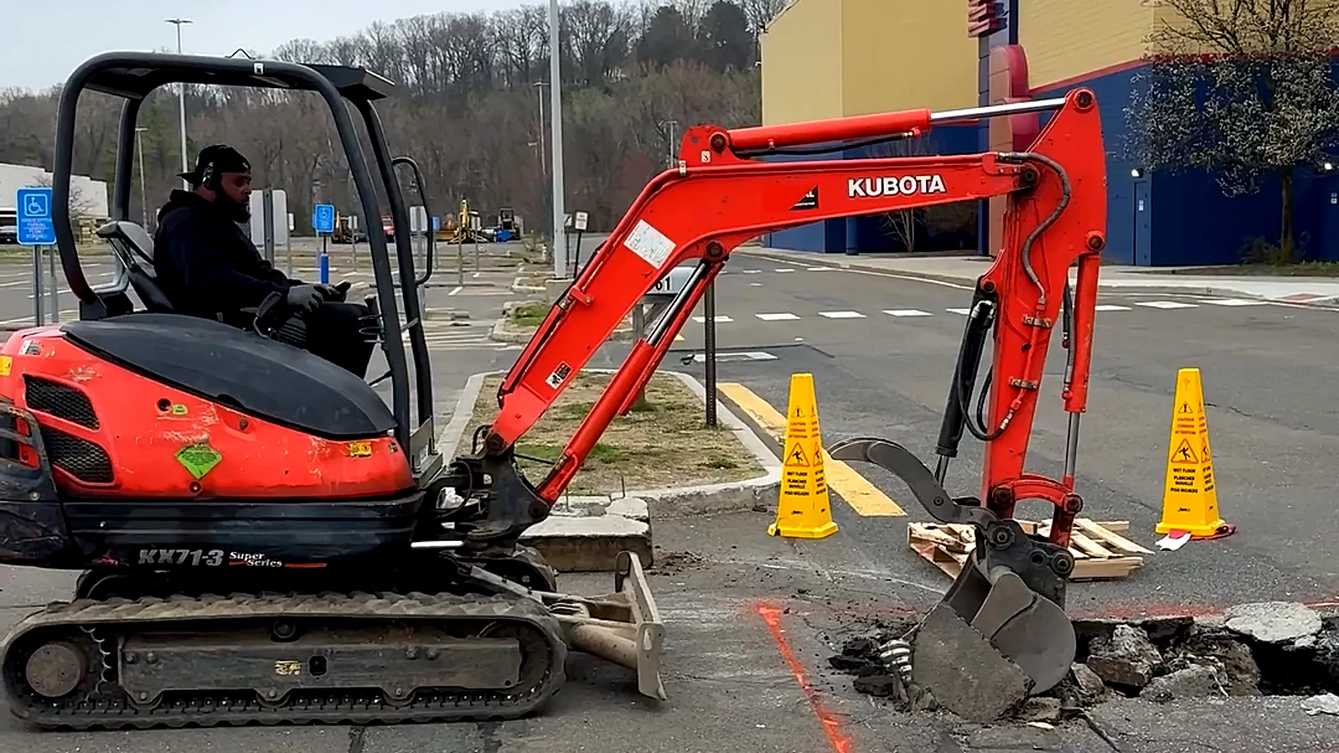 CRL equipment opening pavement for site work in a commercial parking area