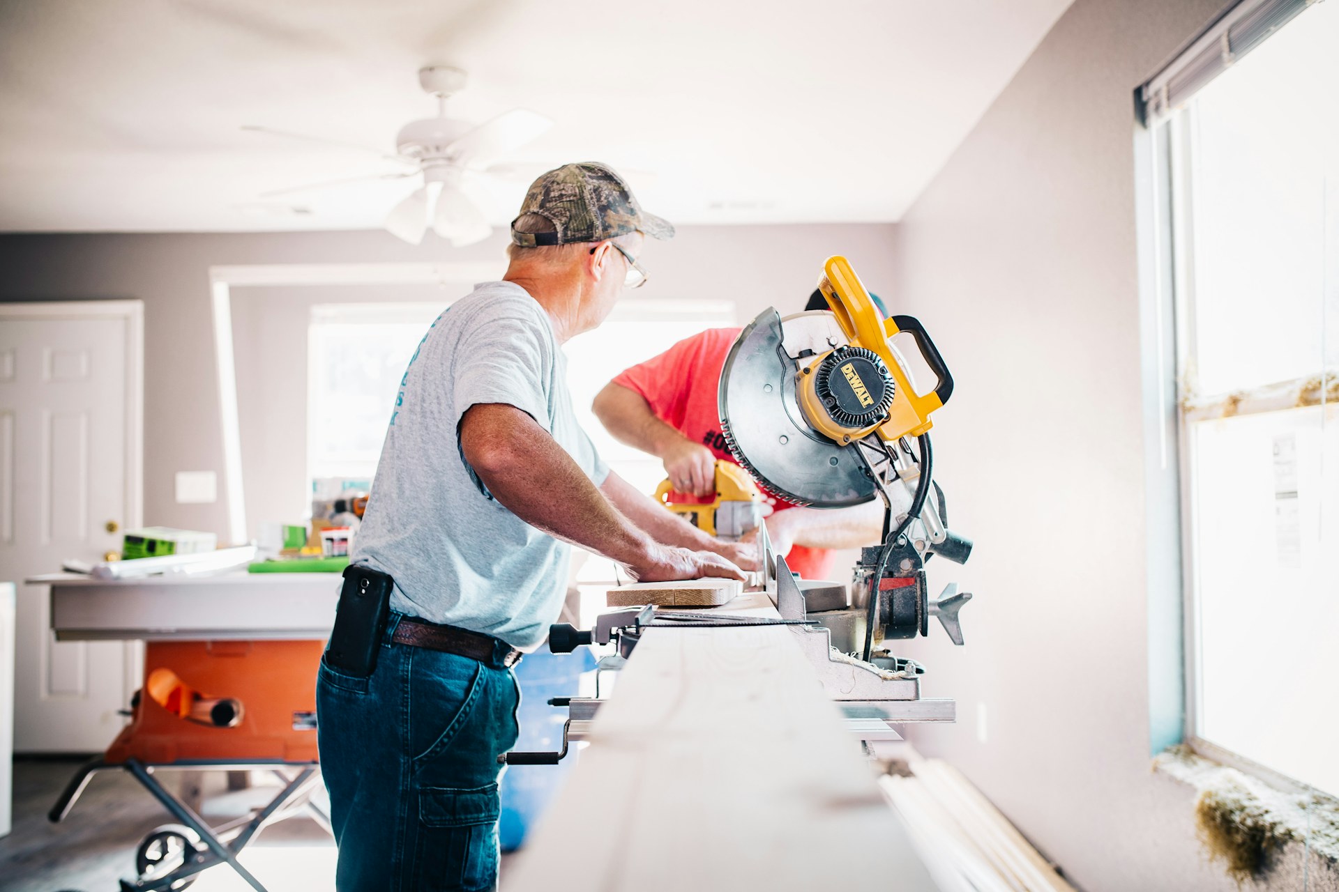 Carpenter working with a miter saw during an interior renovation